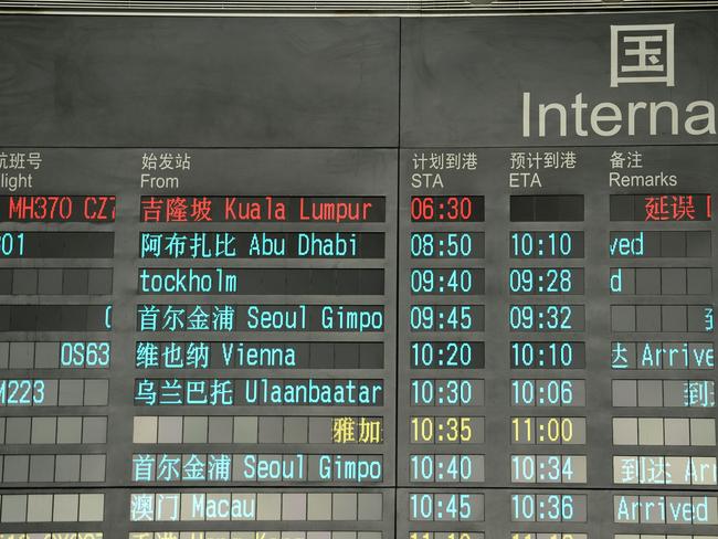 The flight status of MH370 is marked in  red on an arrival board at Beijing Airport.