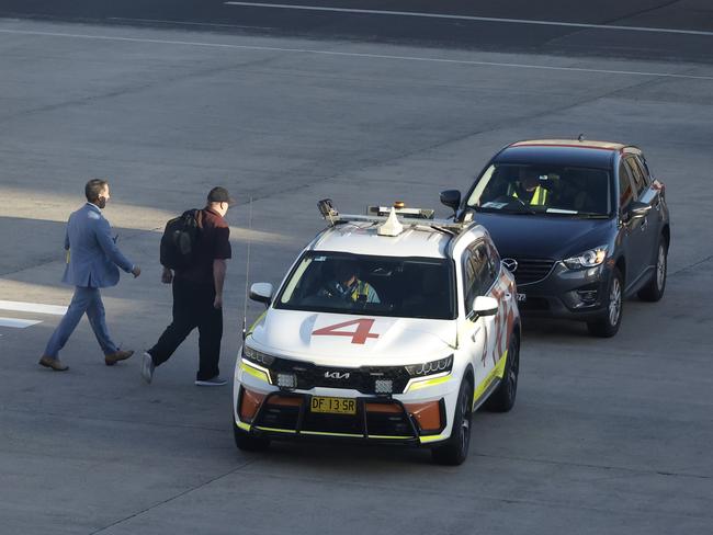 20/12/24: Martin Stephens is helped into a car after arriving at Sydney airport. John Feder/The Australian