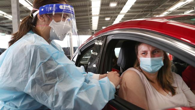 A Victorian woman gets the Pfizer vaccine at Australia’s first drive-through Covid-19 vaccination hub in Melton. Picture: NCA NewsWire/David Crosling