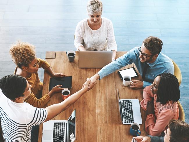 Careers - Group interview/recruitment taskShot of a colleagues shaking hands during a meeting in a modern office