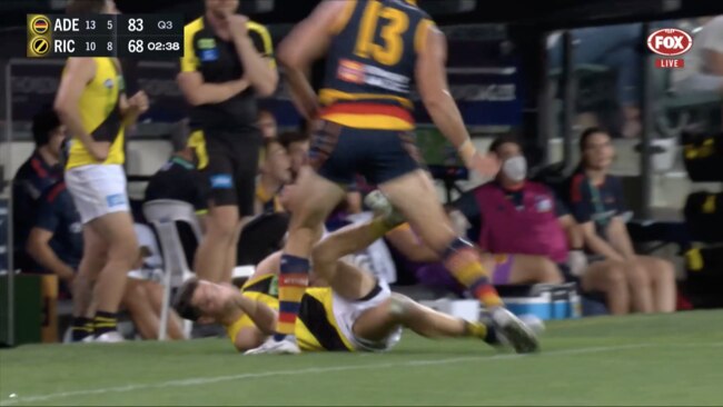 Trent Cotchin makes contact with his boot as Taylor Walker and the grounded Tiger come together on the boundary line. Picture: Fox Footy