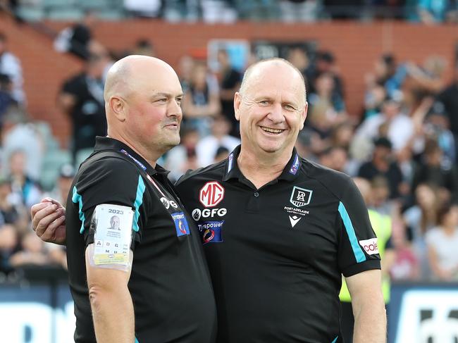 ADELAIDE, AUSTRALIA – MARCH 18: General Manager of Port Adelaide Chris Davies stands with Senior Coach Ken Hinkley after the win during the 2023 AFL Round 01 match between the Port Adelaide Power and the Brisbane Lions at Adelaide Oval on March 18, 2023 in Adelaide, Australia. (Photo by Sarah Reed/AFL Photos via Getty Images)