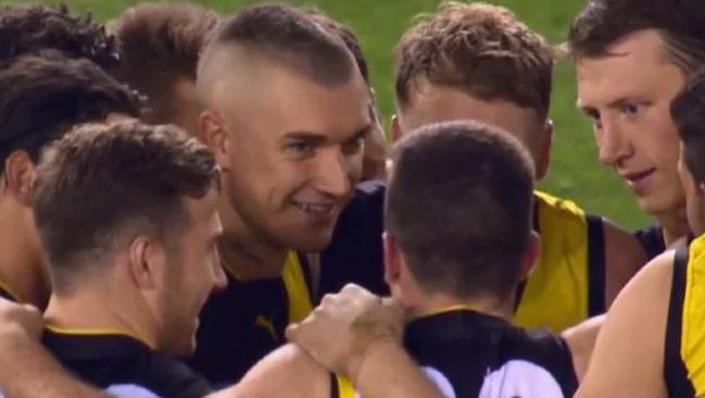 Dustin Martin laughs as Jack Higgins delivers a speech.