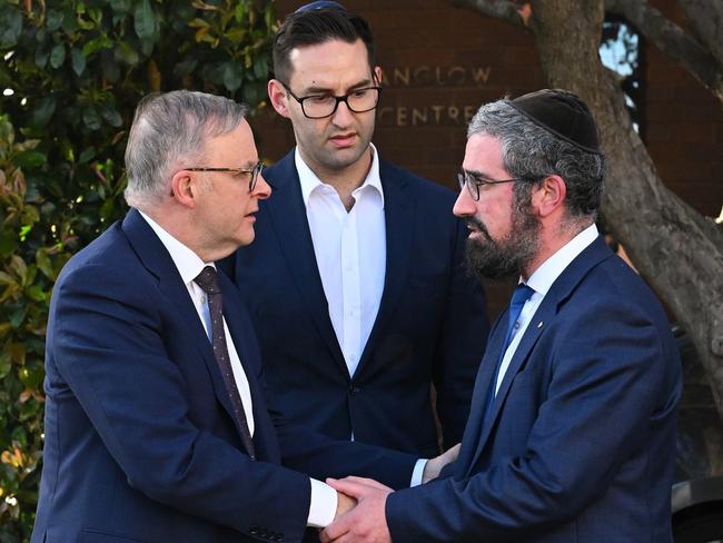 Australian Prime Minister Anthony Albanese (left) and Labor member for MacNamara Josh Burns are greeted by Rabbi Yaakov Glasman (right) during a visit to the St Kilda Shule in Melbourne, Wednesday, October 11, 2023. (AAP Image/James Ross) NO ARCHIVING