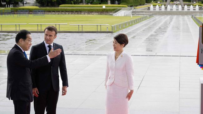 Japanese Prime Minister Fumio Kishida and his wife Yuko welcome France's President Emmanuel Macron at the Peace Park in Hiroshima on Friday. Picture: AFP