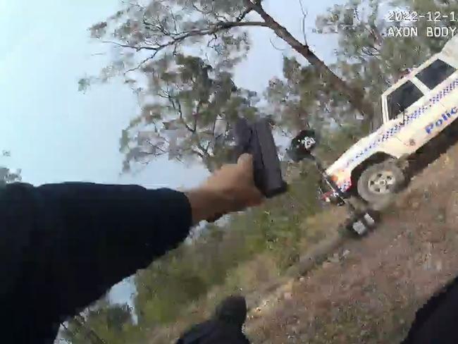 A still from Constable Randall Kirk's body camera running from the Train's Wieambilla property while being shot at.