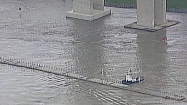 The floating boardwalk is guided down the river below the Gateway bridge. Picture: Nine Network