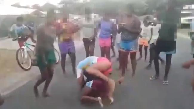 A video uploaded to YouTube shows females engaged in a violent street brawl at Yarrabah while onlookers film with their mobile phones. PICTURE: SCREENSHOT/YOUTUBE