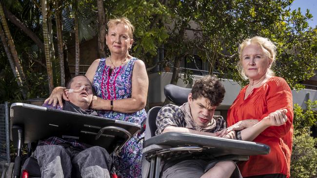 Patricia Dear and her son Kieran and Julie O’Connor with her son Rory stand outside the Halwyn Centre. Picture: Glenn Hunt