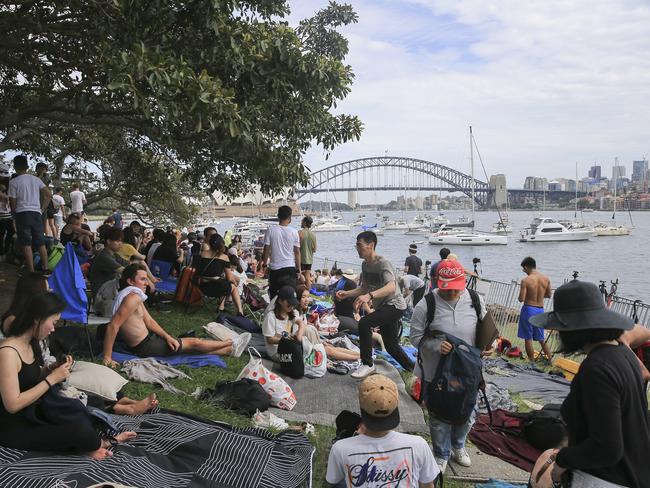 Crowds flock into Mrs Macquarie's Chair to claim positions for tonight's New Years Eve celebrations in Sydney. Picture: Dylan Robinson