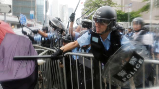 Riot police use batons to keep protesters at bay. Picture: Reuters