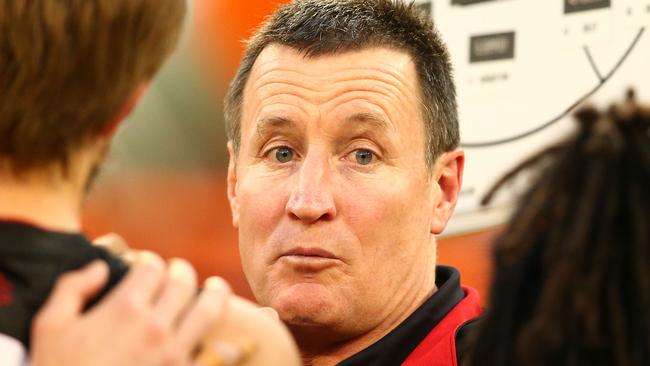 MELBOURNE, VICTORIA - APRIL 25: John Worsfold, coach of the Bombers speaks to his team during a quarter time break during the round five AFL match between the Collingwood Magpies and the Essendon Bombers at Melbourne Cricket Ground on April 25, 2016 in Melbourne, Australia. (Photo by Scott Barbour/AFL Media/Getty Images)