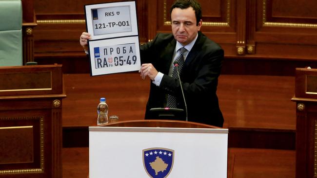 Kosovo Prime Minister Albin Kurti shows Kosovo and Serbia temporary car plates during a parliament session in Pristina on September 20, 2021. Picture: AFP