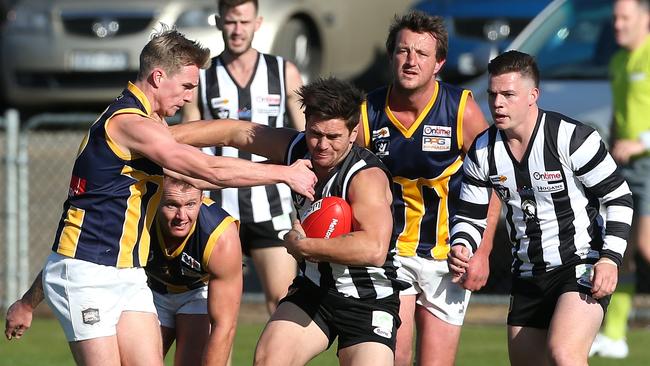 Jesse Davies of Wallan pushes off Lachie Muir of Rupertswood during RDFL footy: Wallan v Rupertswood on Saturday, June 2, 2018, in Wallan, Victoria, Australia. Picture: Hamish Blair