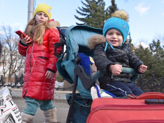 Children wait for their evacuation as growing numbers of people arriving from separatist-held regions in Ukraine received evacuation orders. Picture: AFP