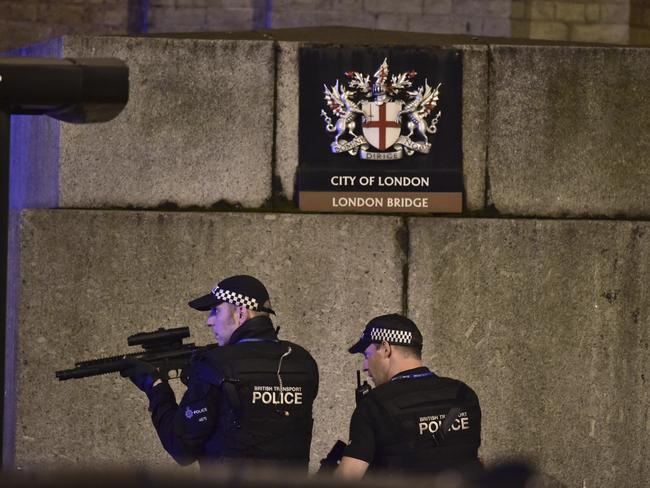 An armed police officer looks through his weapon on London Bridge in London. Picture: PA via AP