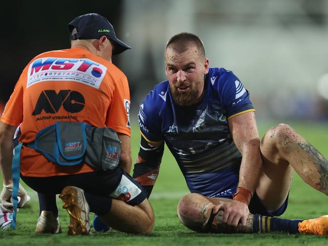 DARWIN, AUSTRALIA - APRIL 19:  Clint Gutherson of the Eels is attended to by a trainer after an injury during the round seven NRL match between Parramatta Eels and Dolphins at TIO Stadium on April 19, 2024, in Darwin, Australia. (Photo by Mark Metcalfe/Getty Images)