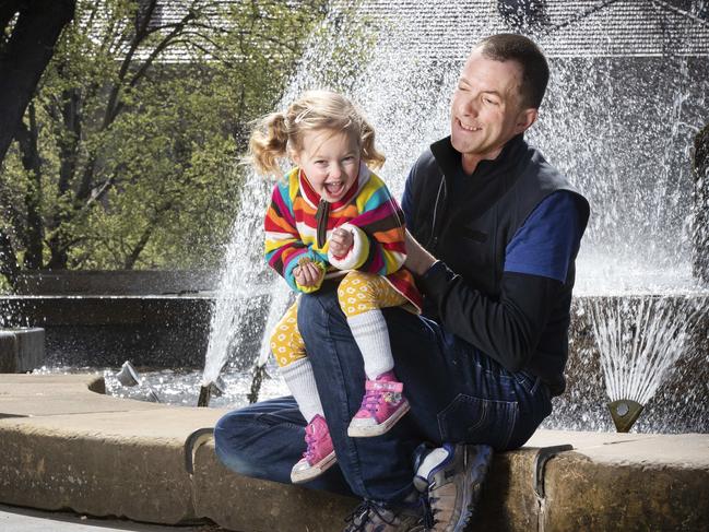 Yoav Daniel Bar-Ness and his daughter Sylvia Tiefholz-Barness, 2, on the hunt for some rainbows in the fountain at Franklin Square. Picture: CHRIS KIDD