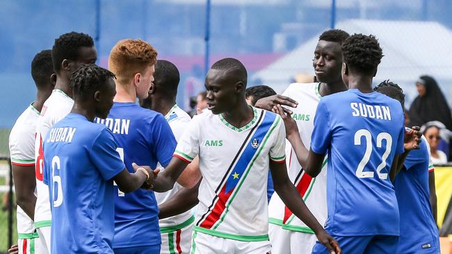 Handshakes all around after the Sudan (blue) and South Sudan clash at the African Nations Cup at Angle Park. (AAP Image/Russell Millard)