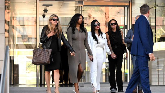 Vanessa Bryant is supported by friends and family as she leaves the court. Photo by Patrick T. FALLON / AFP.