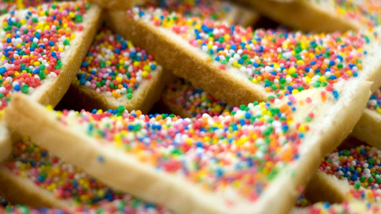 Fairy bread in half-slice triangles, which provides a handle to pick them up with.