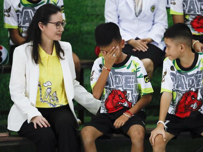 Rescued soccer player ‘Titan’ Chanin Vibulrungruang reacts after paying respect to a portrait of Saman Gunan, the Thai Navy SEAL diver who died in the rescue attempt.