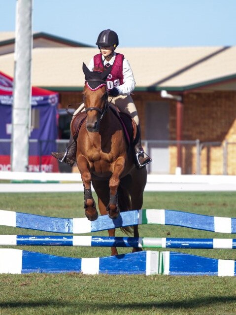 Isabella Hartwig and her horse clear the wavy planks at at the PQC State Showjumping Championships.