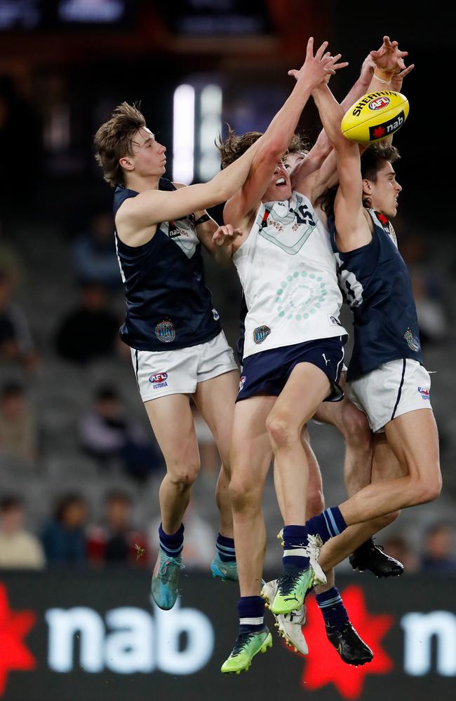 Jakob Anderson (left) flies high against Aaron Cadman and Luke Teal. Picture: Dylan Burns/AFL Photos via Getty Images