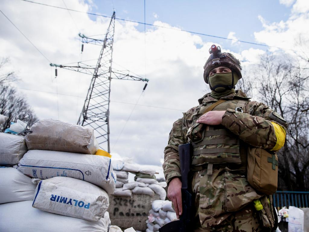 A Ukrainian service member is seen at a check point in the city of Zhytomyr, Ukraine. Picture: AFP