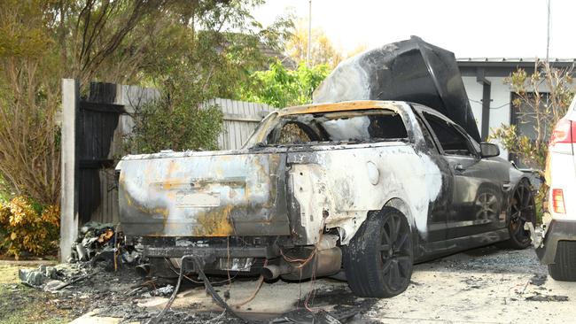 The remains of two burnt cars in the driveway of a Reigate Rd Highton property. Picture: Alison Wynd