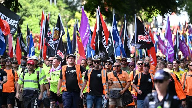 Hundreds of CFMEU members storm the Brisbane CBD in a volatile protest that stopped traffic and saw a glass door smashed. Picture: Lyndon Mechielsen