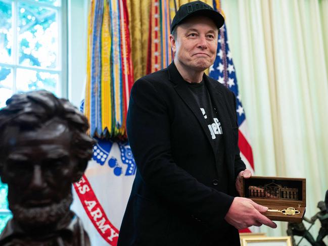 Musk proudly displays the key given to him by Mr Trump. Picture: Allison Robbert / AFP