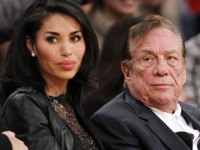 FILE - In this Dec. 19, 2010, file photo, Los Angeles Clippers owner Donald Sterling, right, and V. Stiviano, left, watch the Clippers play the Los Angeles Lakers during an NBA preseason basketball game in Los Angeles. NBA Commissioner Adam Silver is intent on moving quickly in dealing with the racially charged scandal surrounding Clippers owner Sterling. The NBA league will discuss its investigation Tuesday, April 29, 2014, before the Clippers play Golden State in Game 5 of their playoff series. (AP Photo/Danny Moloshok, File)