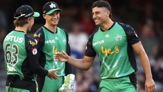 Marcus Stoinis celebrates a wicket with Adam Zampa and Peter Handscomb.