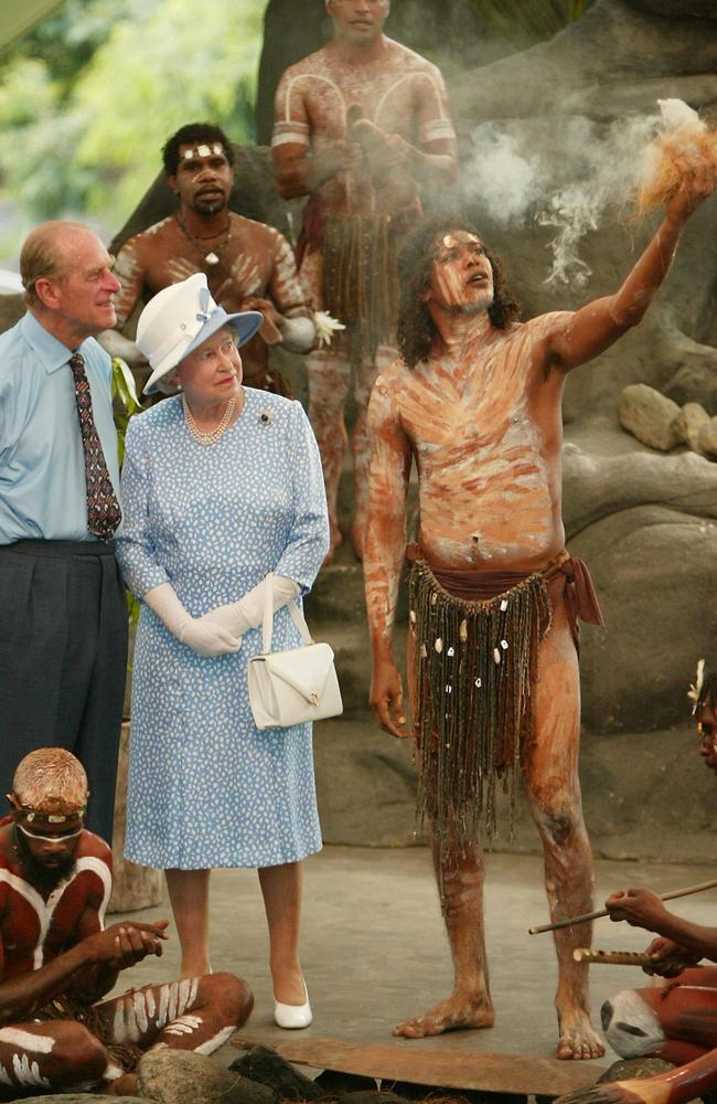 Queen Elizabeth II Prince Philip (L) watch Tjapukai Aborigines light a ceremonial fire during a cultural performance near Cairns in 2002. Picture: AFP