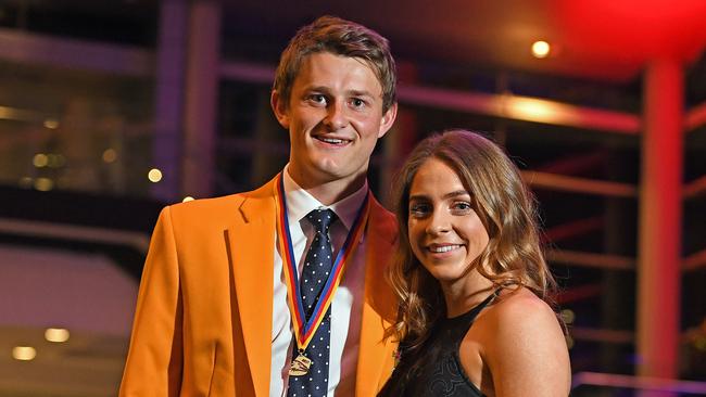 Matt Couch, with partner Ellie Symons, wears the yellow jacket after winning his first Crows club champion award in October. He has extended his contract until the end of 2021. Picture: Tom Huntley