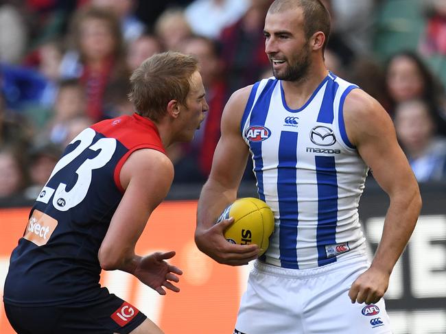 Ben Cunnington of the Kangaroos (right) punches Bernie Vince of the Demons in the stomach during the Round 9 AFL match between the Melbourne Demons and the North Melbourne Kangaroos at the MCG in Melbourne, Sunday, May 21, 2017. (AAP Image/Julian Smith) NO ARCHIVING, EDITORIAL USE ONLY