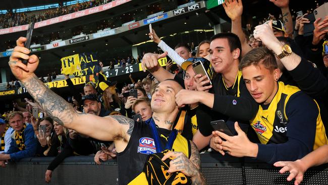 Dustin Martin of the Tigers celebrates with fans after the 2019 AFL Grand Final match between the Richmond Tigers and the GWS Giants at the MCG on September 28, 2019 in Melbourne, Australia. Picture: Mark Stewart