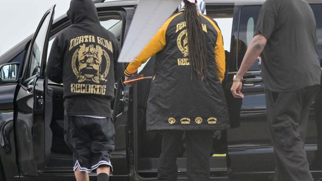 US hip-hop star Snoop Dogg, in the yellow jacket, arrives at Adelaide Airport. Picture: NCA NewsWire / Brenton Edwards