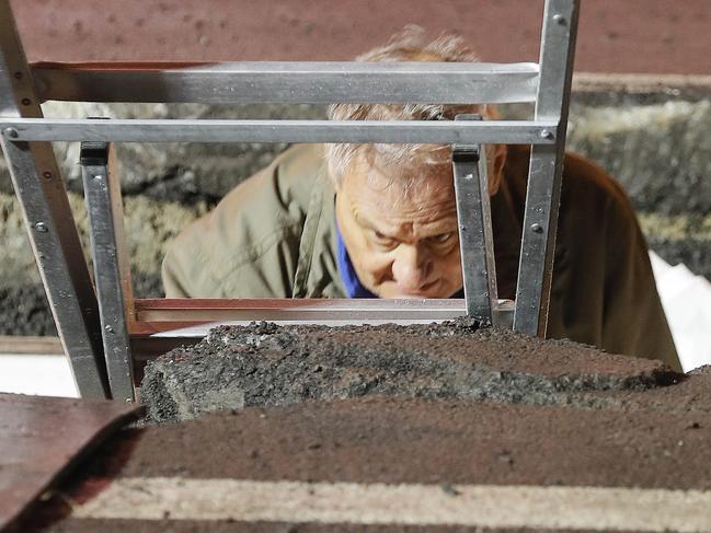 Mike Parr's emergence from beneath Macquarie St, Hobart, where he stayed for 72 hours as part of the Dark Mofo festival. Picture: MATHEW FARRELL