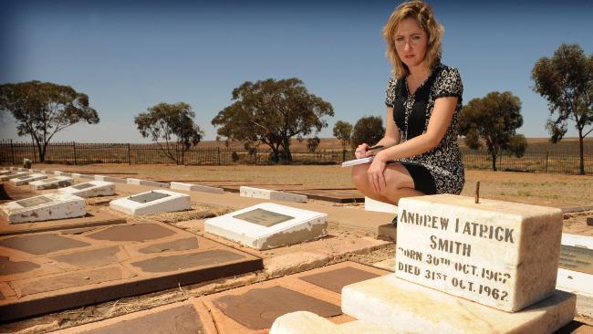 QUESTIONS: British lawyer Anna Mazzola notes details of babies' graves in Woomera Cemetery. Picture: MARK BRAKE