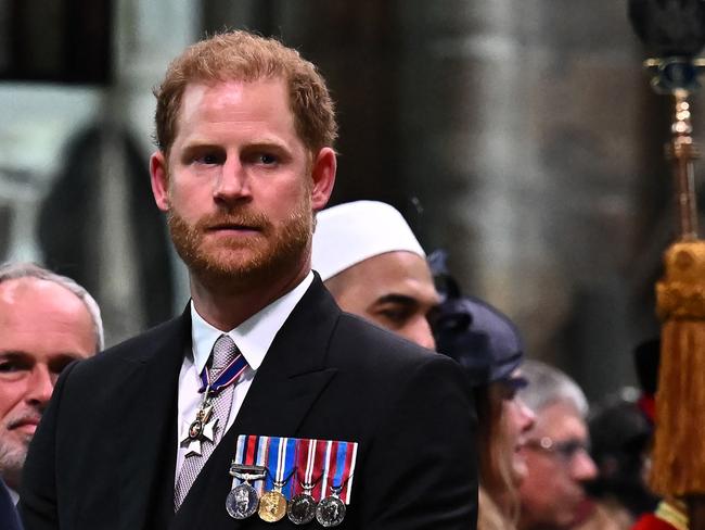 TOPSHOT - Britain's Prince Harry, Duke of Sussex looks on as Britain's King Charles III leaves Westminster Abbey after the Coronation Ceremonies in central London on May 6, 2023. - The set-piece coronation is the first in Britain in 70 years, and only the second in history to be televised. Charles will be the 40th reigning monarch to be crowned at the central London church since King William I in 1066. Outside the UK, he is also king of 14 other Commonwealth countries, including Australia, Canada and New Zealand. (Photo by Ben Stansall / POOL / AFP)