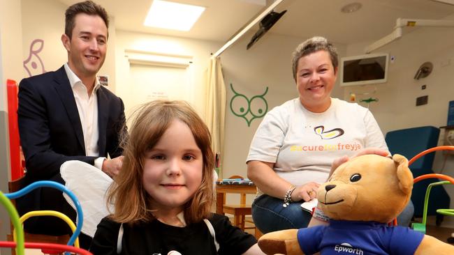 Dr Ben Dixon with Freyja Christiansen, then six, and her mother Liz Christiansen Young at the Epworth Hospital before surgery. Picture: David Geraghty