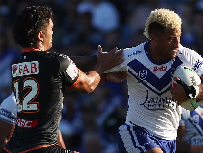 SYDNEY, AUSTRALIA - MARCH 19: Viliame Kikau of the Bulldogs   is tackled by Shawn Blore of the Wests Tigers during the round three NRL match between Canterbury Bulldogs and Wests Tigers at Belmore Sports Ground on March 19, 2023 in Sydney, Australia. (Photo by Mark Metcalfe/Getty Images)