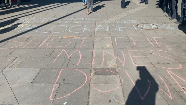 Slogans are written in chalk outside the centre.