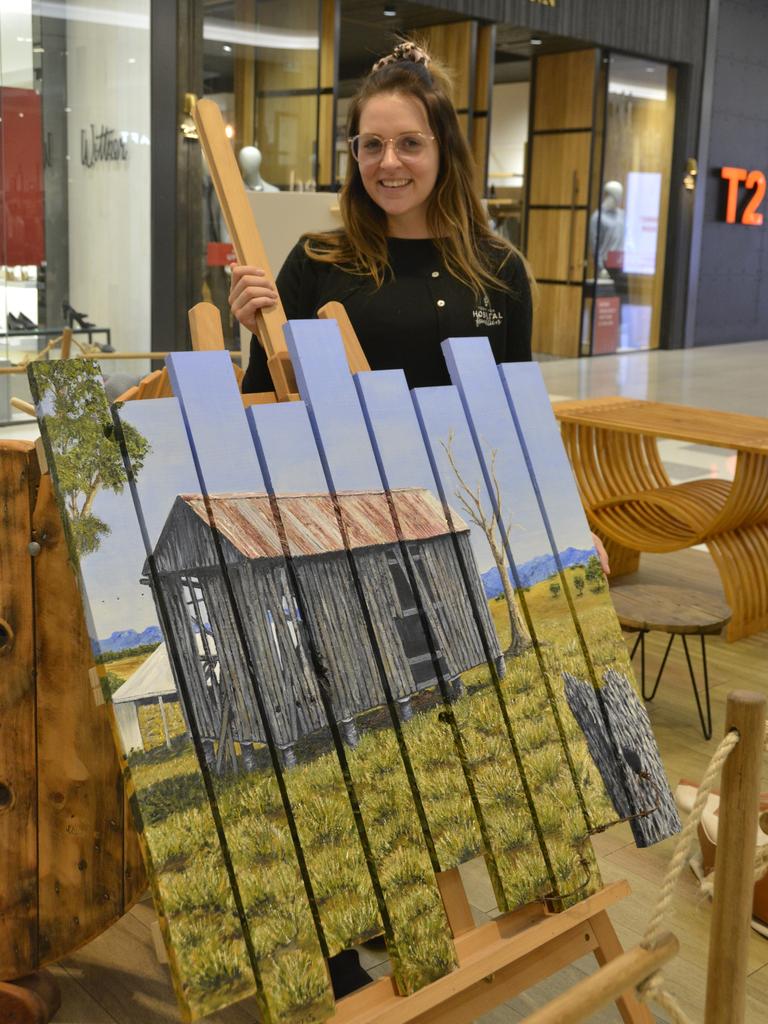 Toowoomba Hospital Foundation’s Emma Manteufel stands with one of the artworks available for auction. Picture: Rhylea Millar