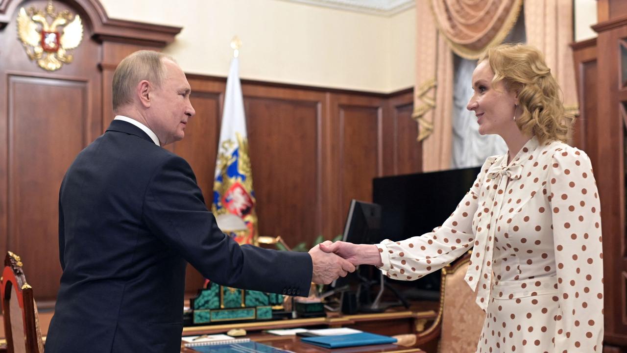 Putin meets with Commissioner for Children's Rights Maria Lvova-Belova at the Kremlin in Moscow on March 9, 2022. An arrest warrant is also out on her. (Photo by Mikhail Klimentyev / SPUTNIK / AFP)