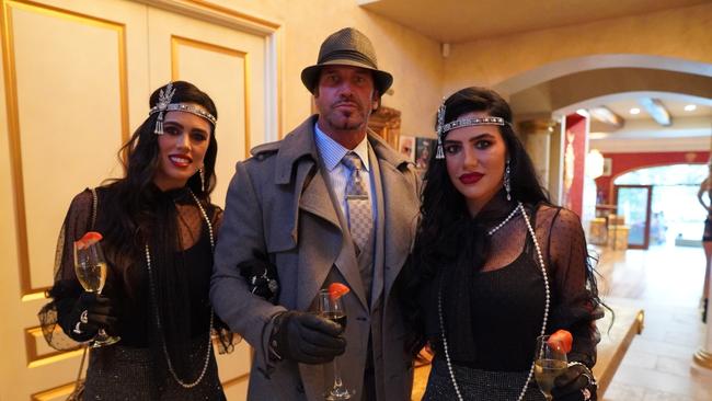 Tobacco franchise tycoon Travers 'Candyman' Beynon with wife Taesha (left) and girlfriend Nisha at the New Year's Eve party he hosted at the Candy Shop Mansion in Helensvale