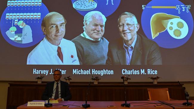 Nobel Committee member Patrik Ernfors sits in front of a screen displaying the winners of the 2020 Nobel Prize in Physiology or Medicine, American Harvey Alter, left, Briton Michael Houghton and American Charles Rice, at the Karolinska Institute in Stockholm, Sweden, on Monday. Picture: AFP