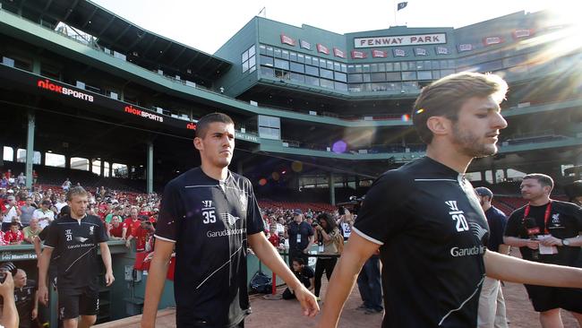 Liverpool F.C. team members from right Adam Lallana (20), Conor Coady (35), and Lucas Leiva (21) enter the field for practice at Fenway Park in Boston, Tuesday, July 22, 2014 in preparation for their friendly soccer match against A.S. Roma scheduled for Wednesday. (AP Photo)